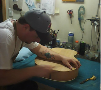 Robert Brooks repairs guitar