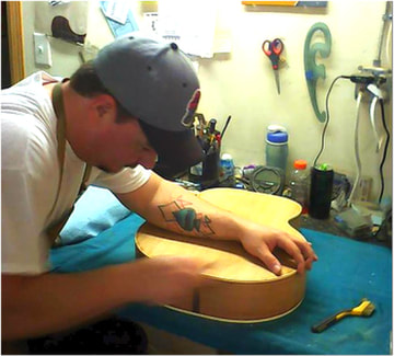 Robert Brooks repairs guitar